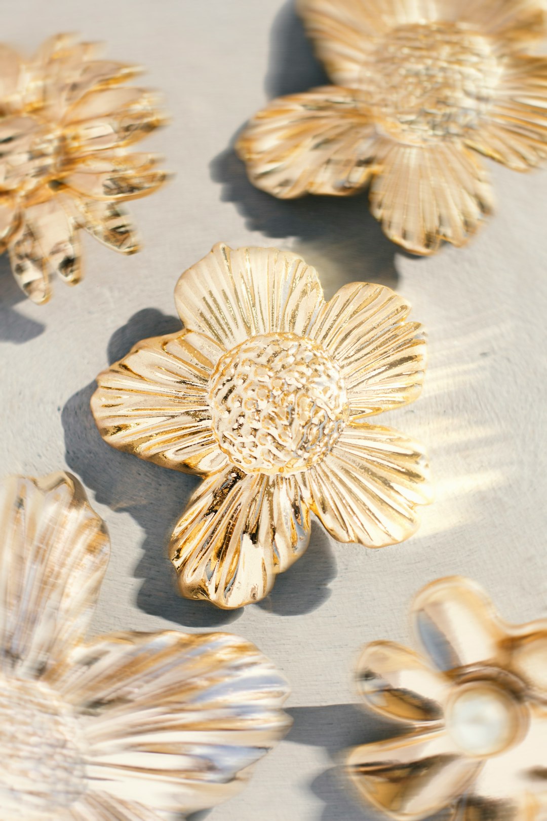 Metal flower embellishments for use in making fashion bags and footwear with a distorted and blurred effect under natural sunlight. - photoshoot for @WSmetais